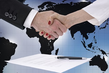 shaking hands over map